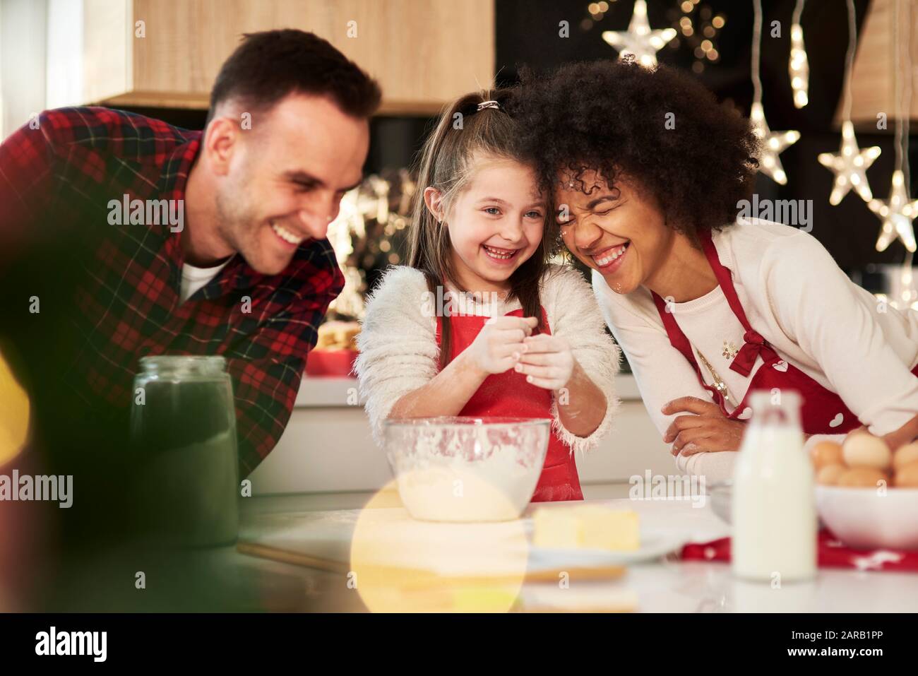 Family preparing snack in kitchen Stock Photo