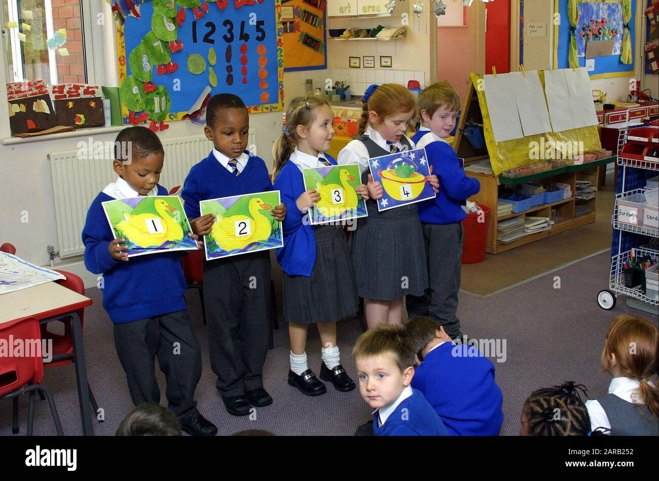 uniformed primary students working with numbers in a arithmetic lesson Stock Photo