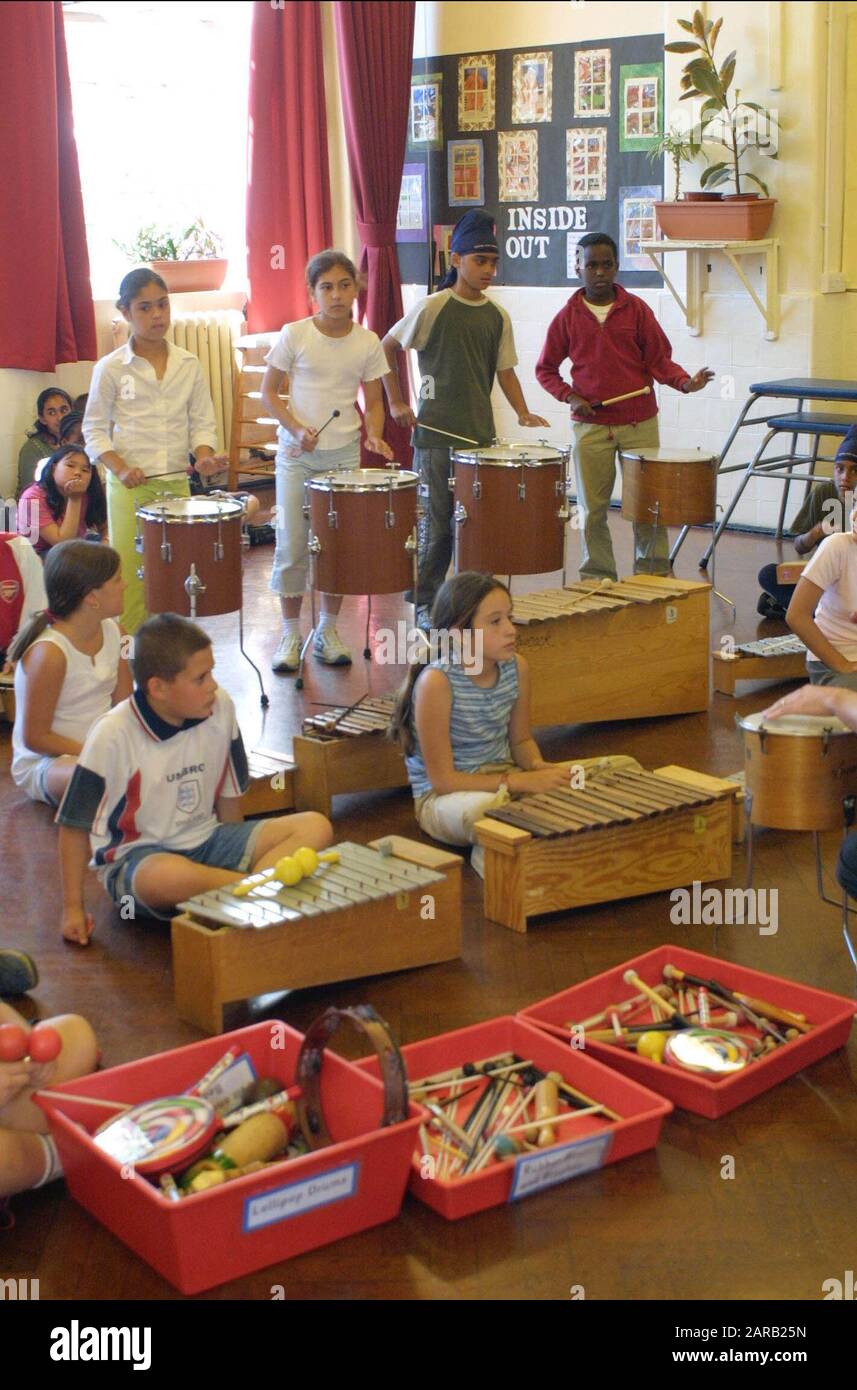 primary school music class with children playing on percussive instruments Stock Photo