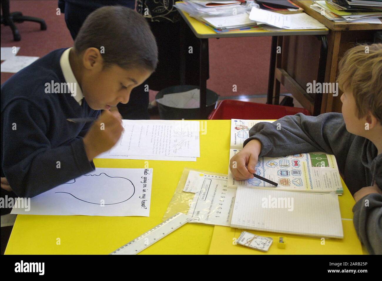 primary school math lesson showing boys working out math problems. Stock Photo