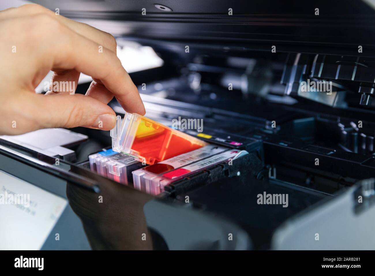 office equipment maintenance and service - hand replace inkjet printer cartridge Stock Photo