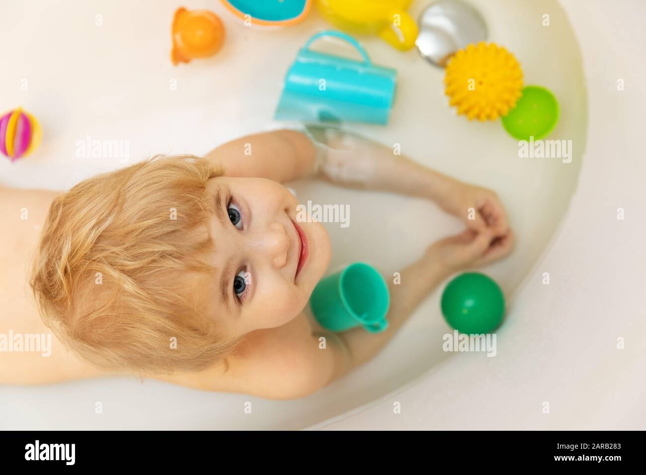 happy child taking a bath and playing with toys. top view Stock Photo