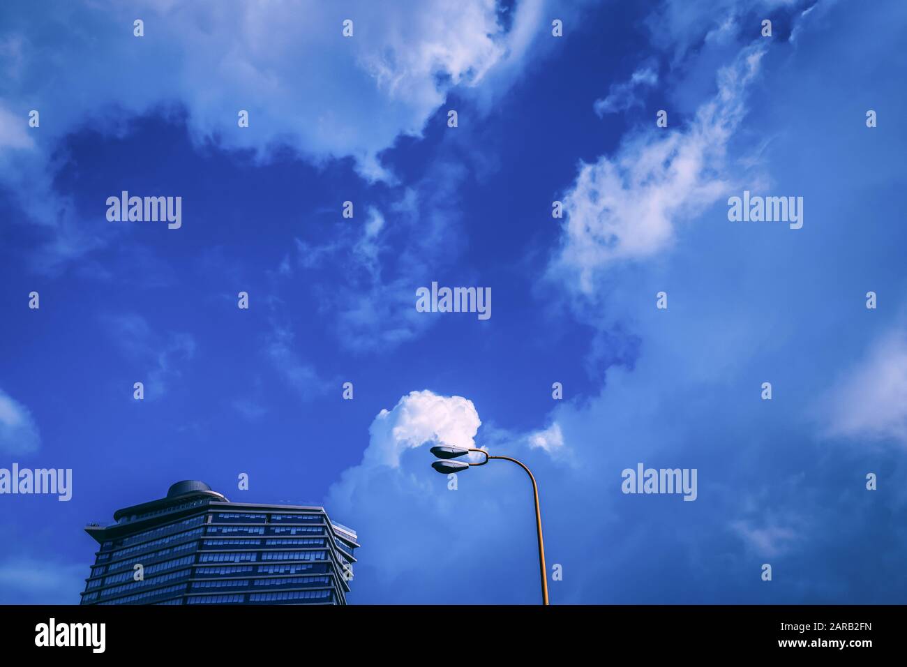 Modern high-rise architecture with a partially cloudy sky Stock Photo ...