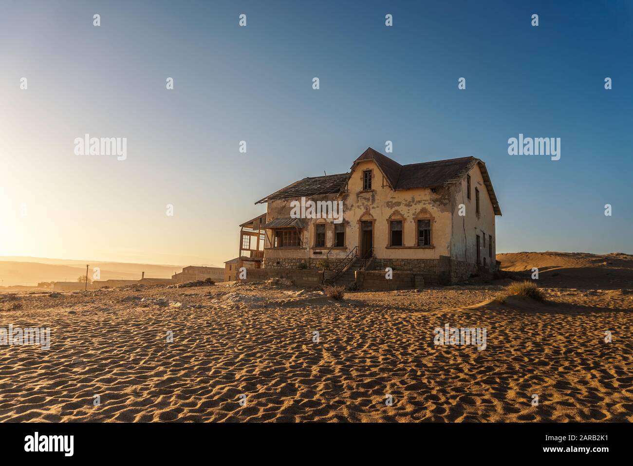 Sunrise above an abandoned house in Kolmanskop ghost town, Namibia Stock Photo