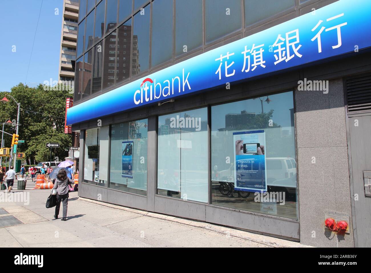 NEW YORK, USA - JULY 6, 2013: People walk by Citibank branch in New York Chinatown. Citibank is part of Citigroup, multinational financial service pro Stock Photo