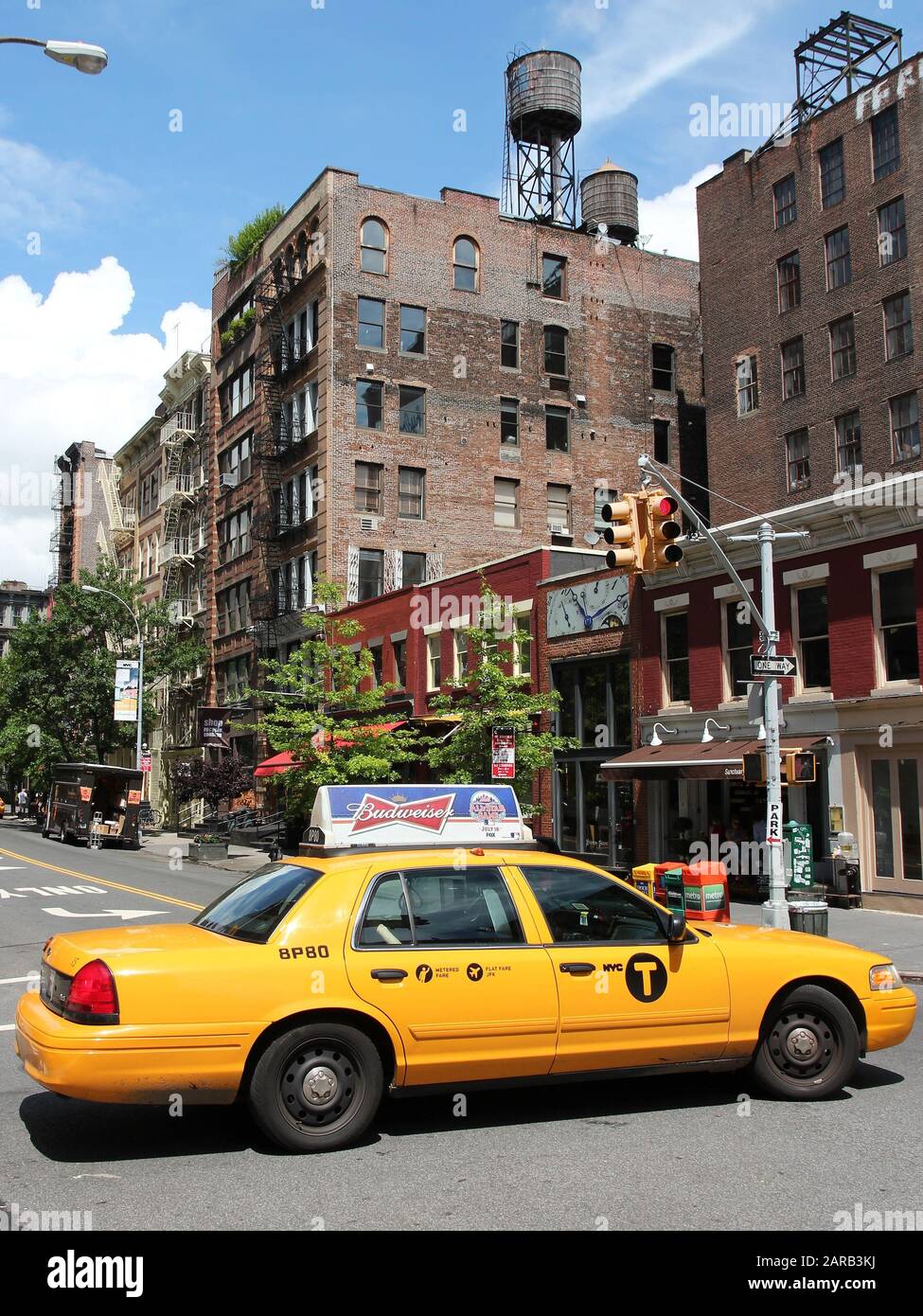NEW YORK, USA - JULY 2, 2013: People ride yellow taxi in SoHo, New York. As of 2012 there were 13,237 yellow taxi cabs registered in New York City. Stock Photo
