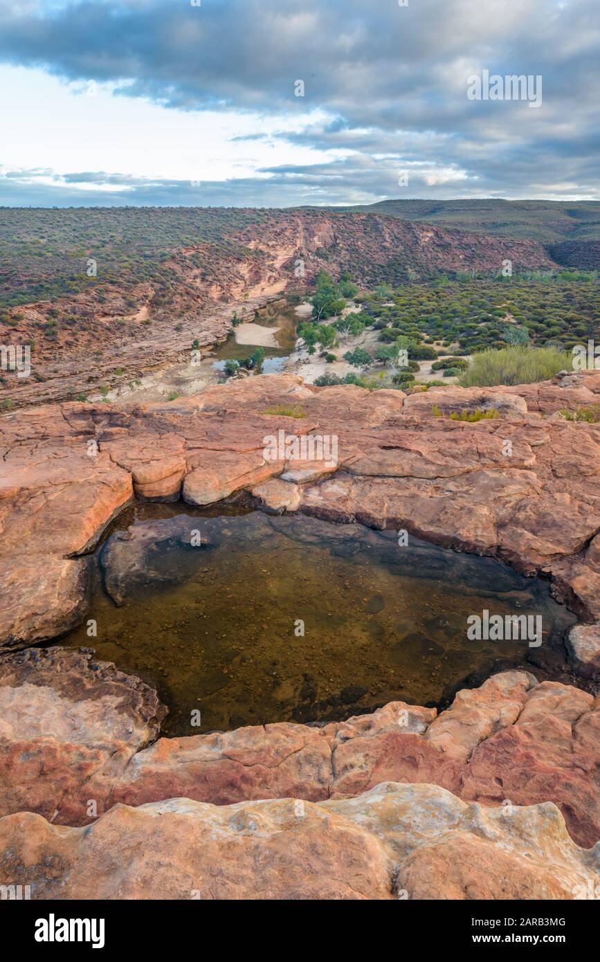 Rock pool atop Nature's Window overlooking the Murchison River Gorge early morning. Stock Photo