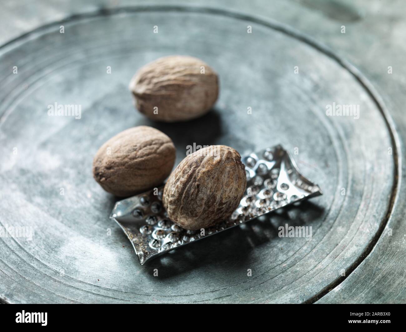 nutmegs in a metal plate Stock Photo
