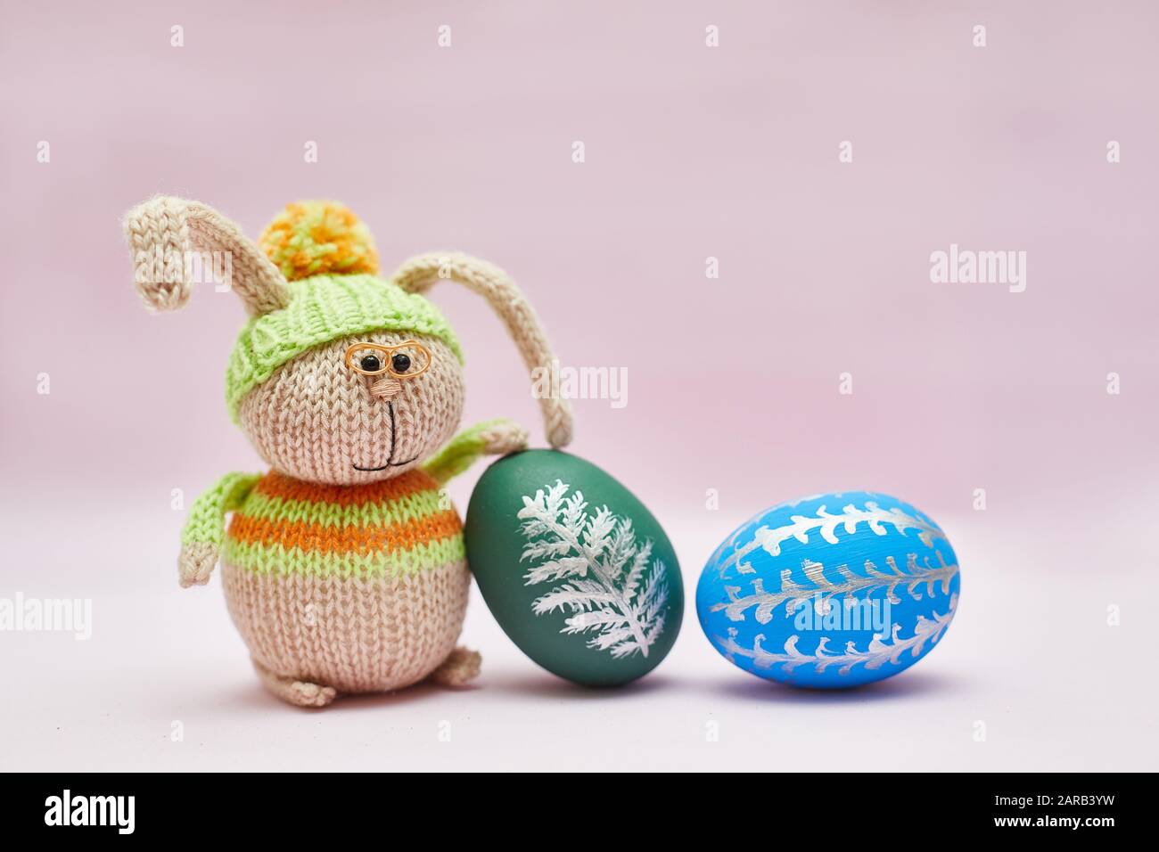 knitted rabbit and two Easter eggs for a postcard Stock Photo