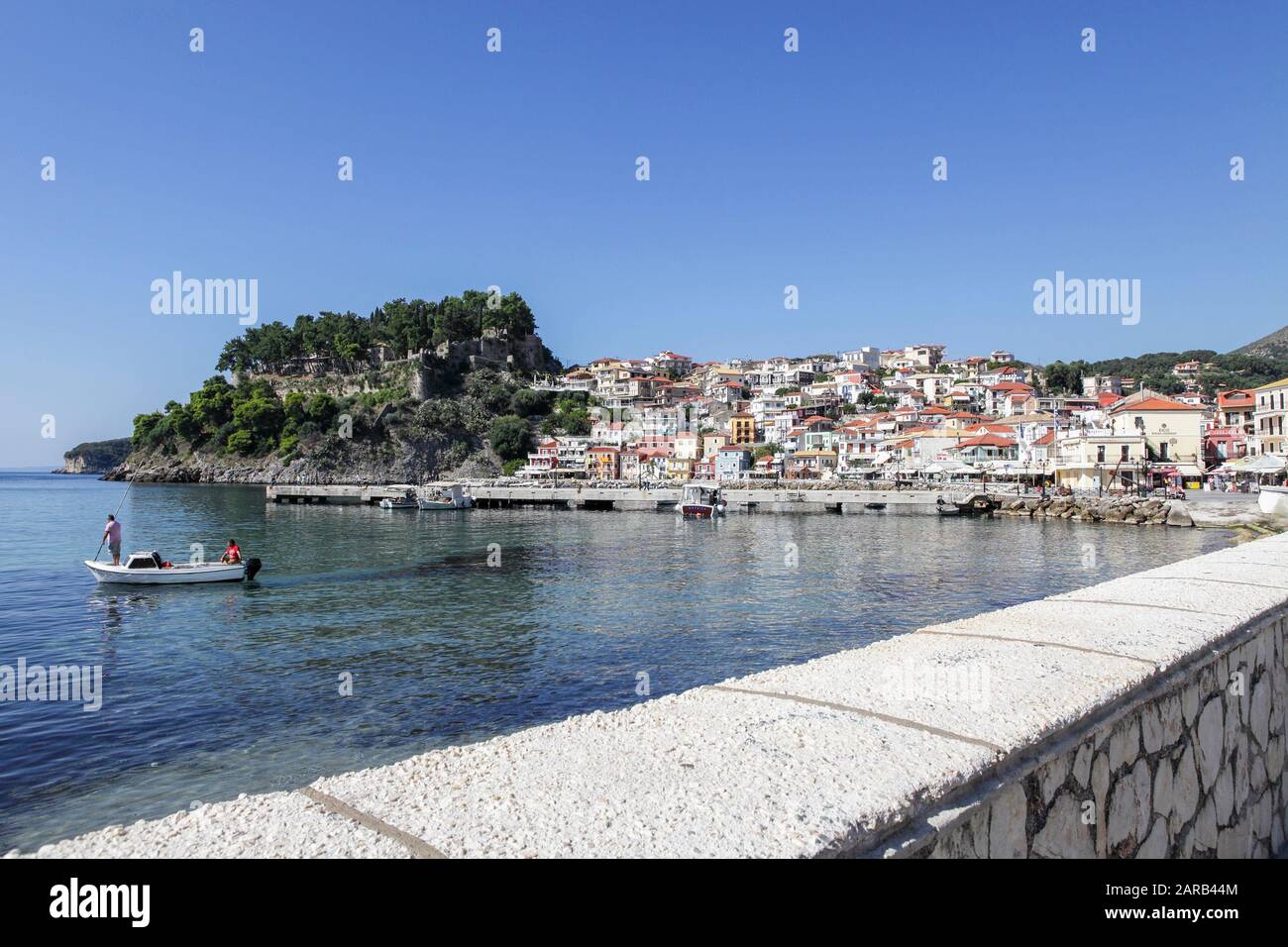 Viewed here and set in the Ionian Sea lies the beautiful Greek Town of Parga.Local fishermen visible in their small boat. Stock Photo