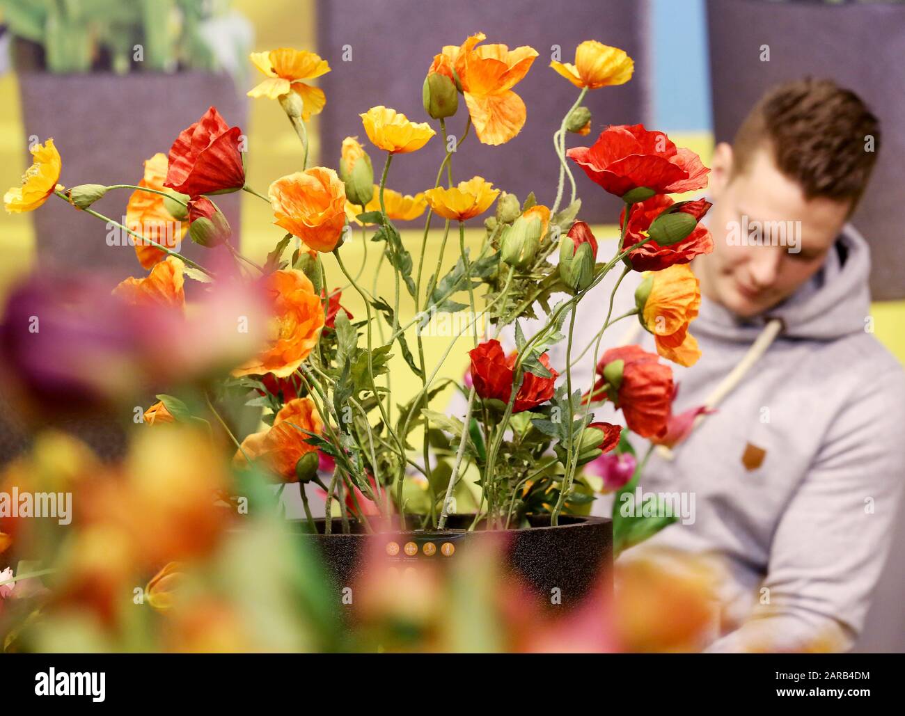 Essen, Germany. 27th Jan, 2020. A florist decorates artificial flowers at his stand. The splendour of flowers can be seen at the International Plant Fair IPM, which will show everything to do with plants from 28.01. to 30.01.2020. Credit: Roland Weihrauch/dpa/Alamy Live News Stock Photo
