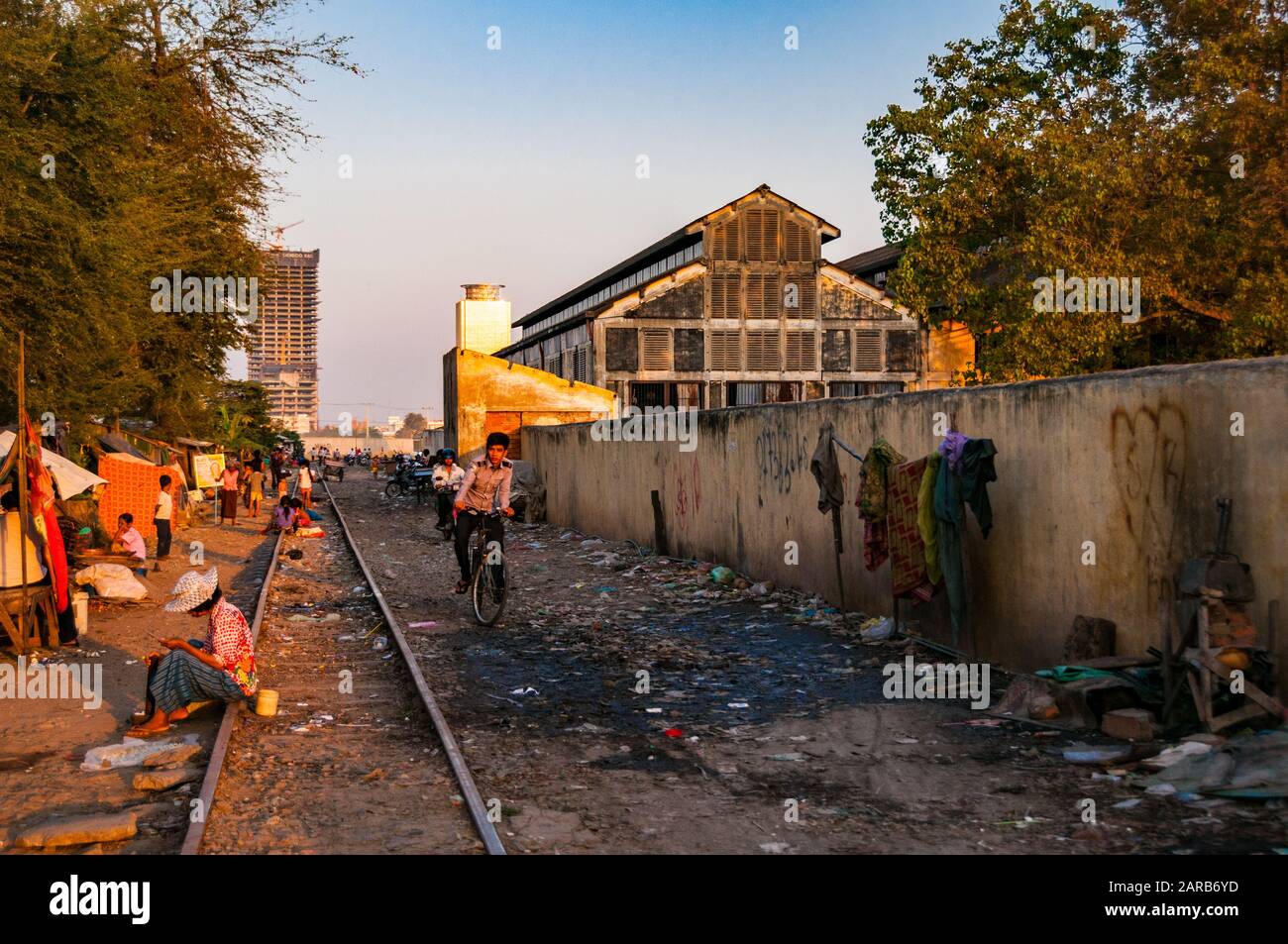 Slum area along the tracks with the French era engine sheds and workshops to the right near Phnom Penh Station, Cambodia Stock Photo