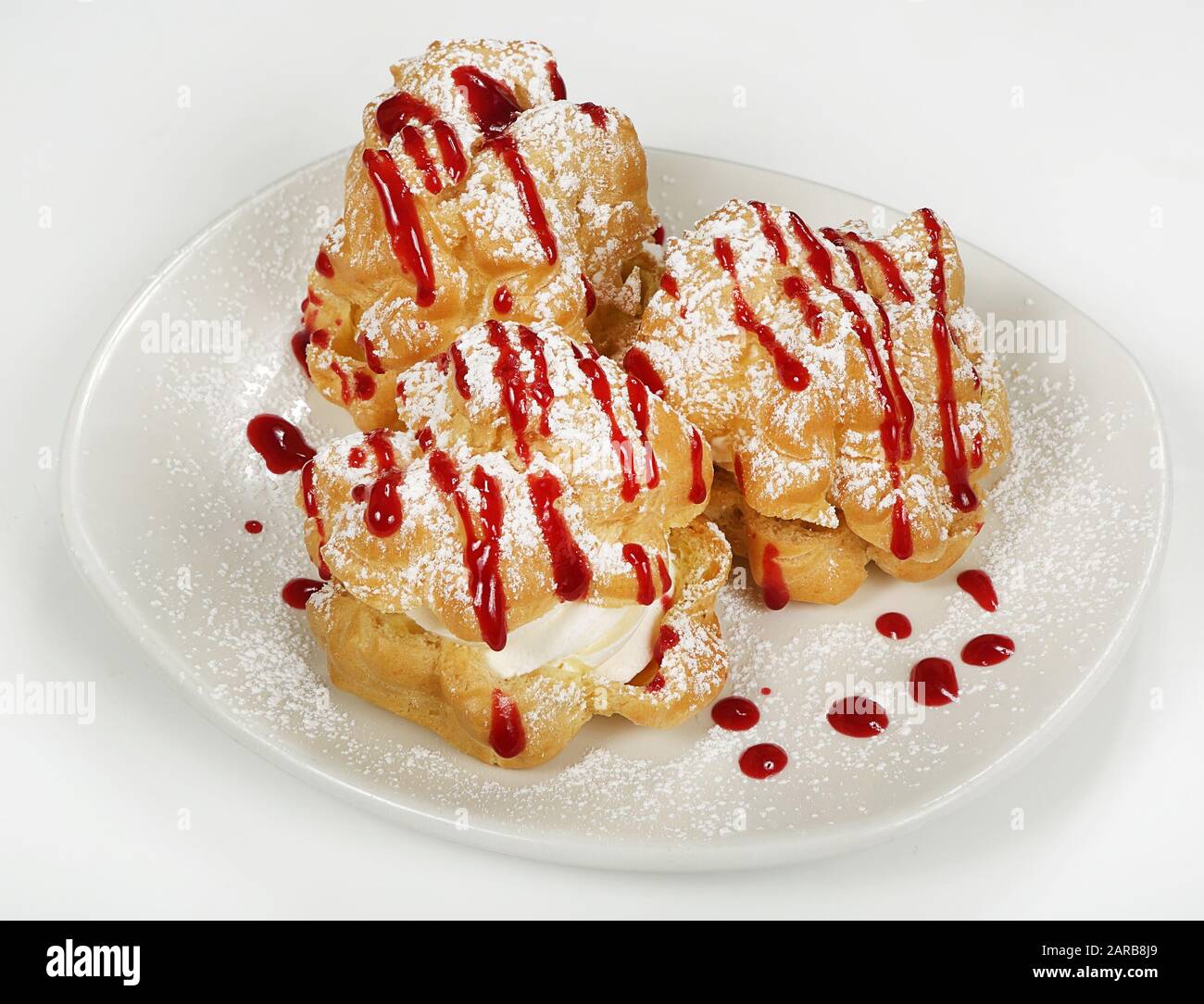 Profiteroles With Cottage Cheese Cream Or Ice Cream On A Plate