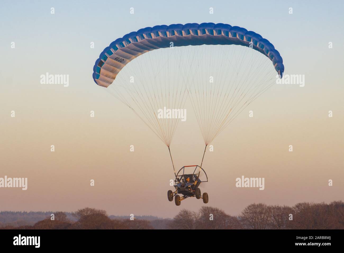 flying car flying, with a blue parachute wing Stock Photo Alamy