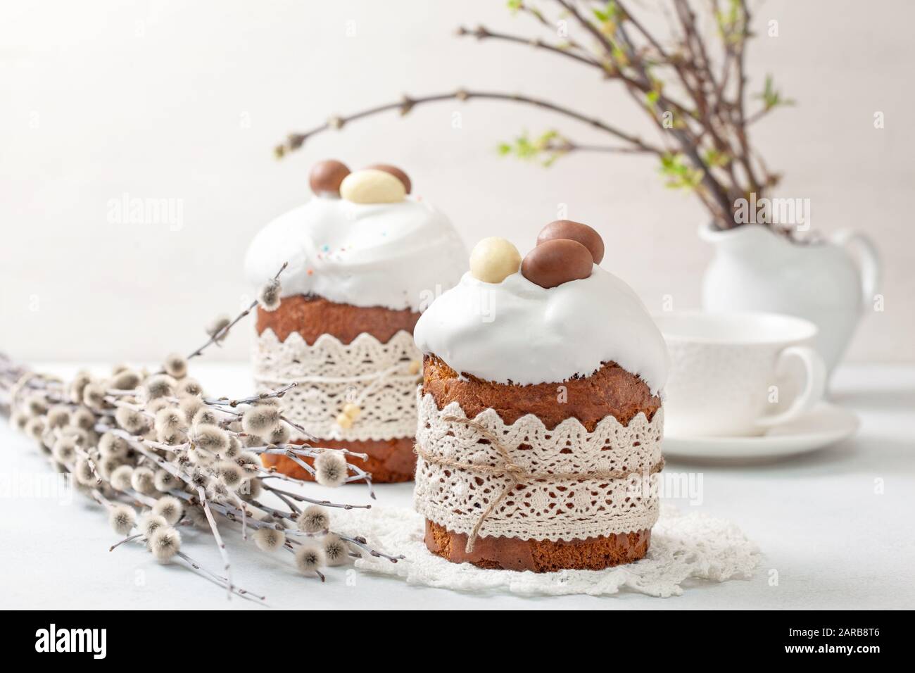 Easter composition with Easter cake (kulich), willow branches on a light background Stock Photo