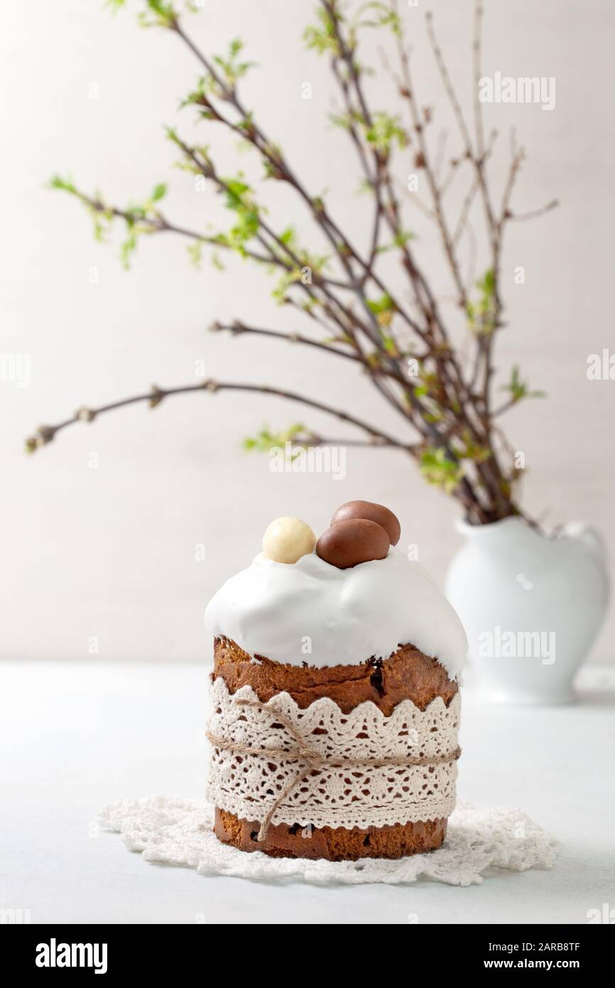 Easter composition with Easter cake (kulich), willow branches on a light background Stock Photo