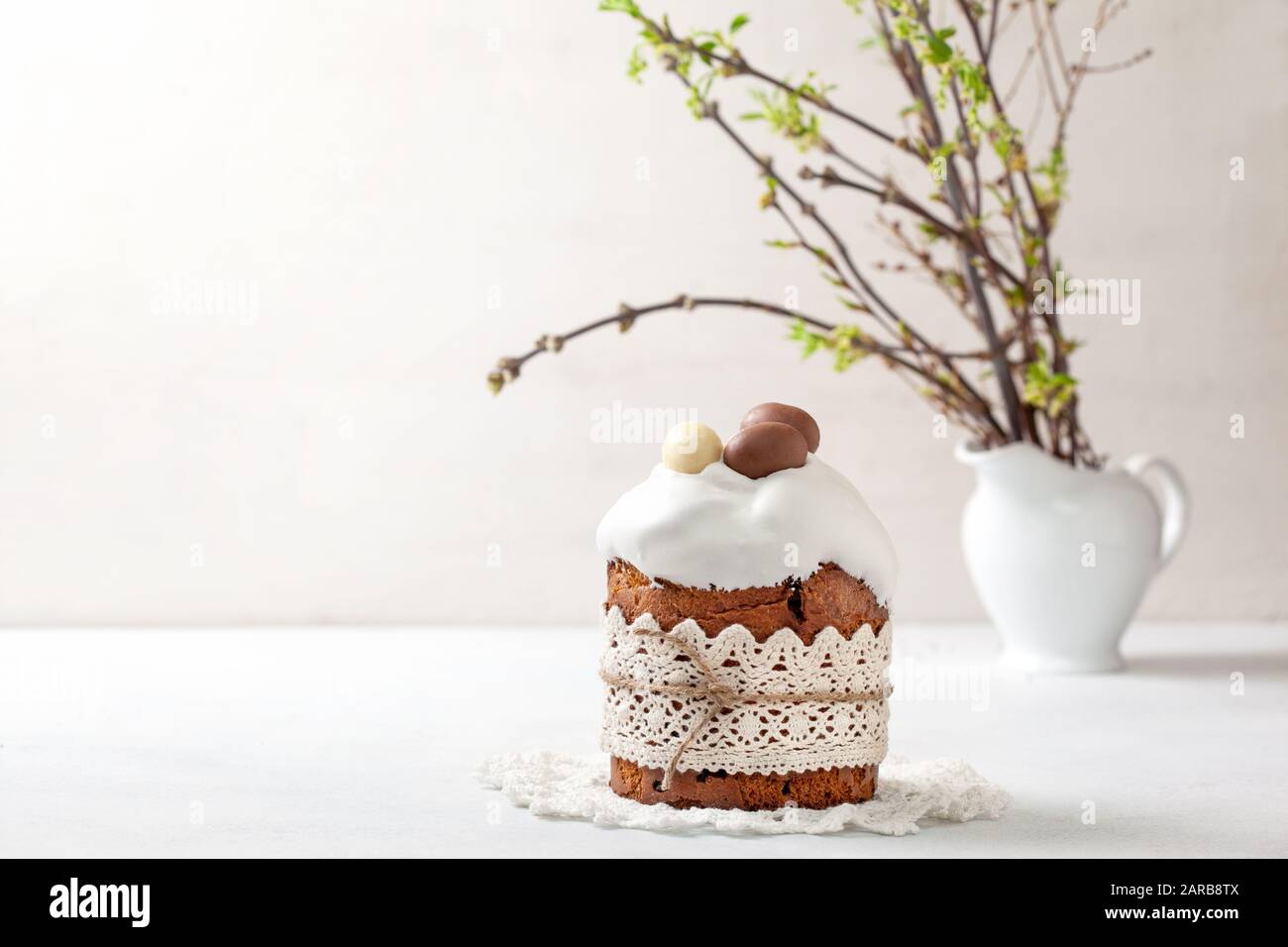 Easter composition with Easter cake (kulich), willow branches on a light background Stock Photo