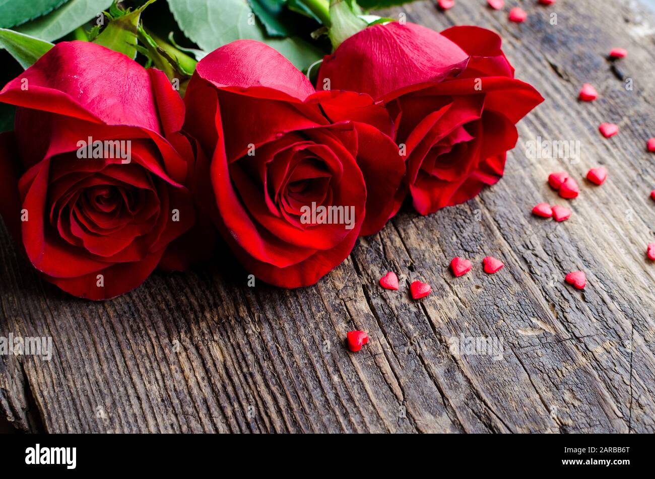 Red roses flowers on old wooden background with place for text. Romantic  Valentines holidays concept. Valentine's day greeting card. Copy space  Stock Photo - Alamy