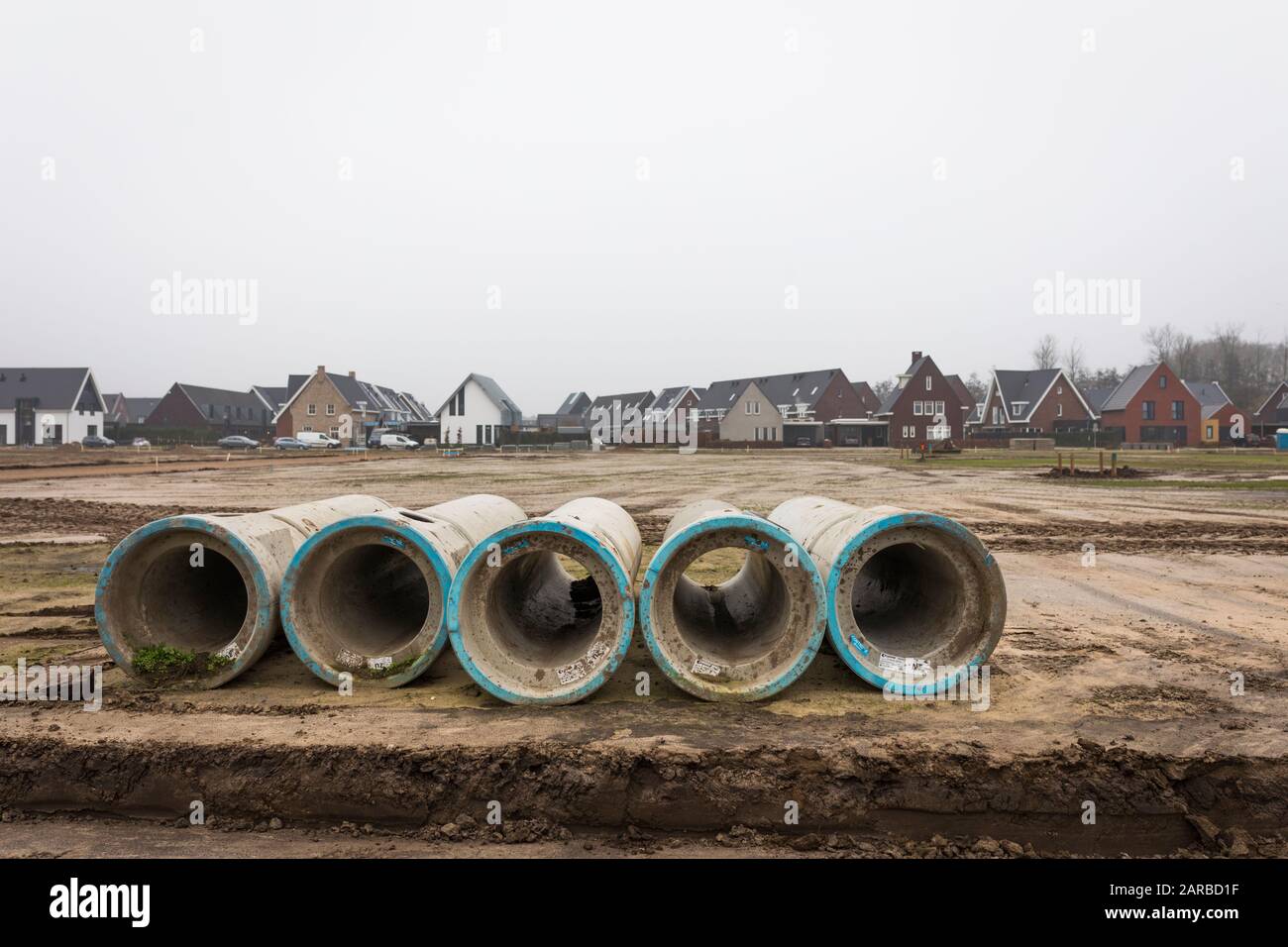 Concrete sewer pipes for ground work at new building location in the Netherlands Stock Photo