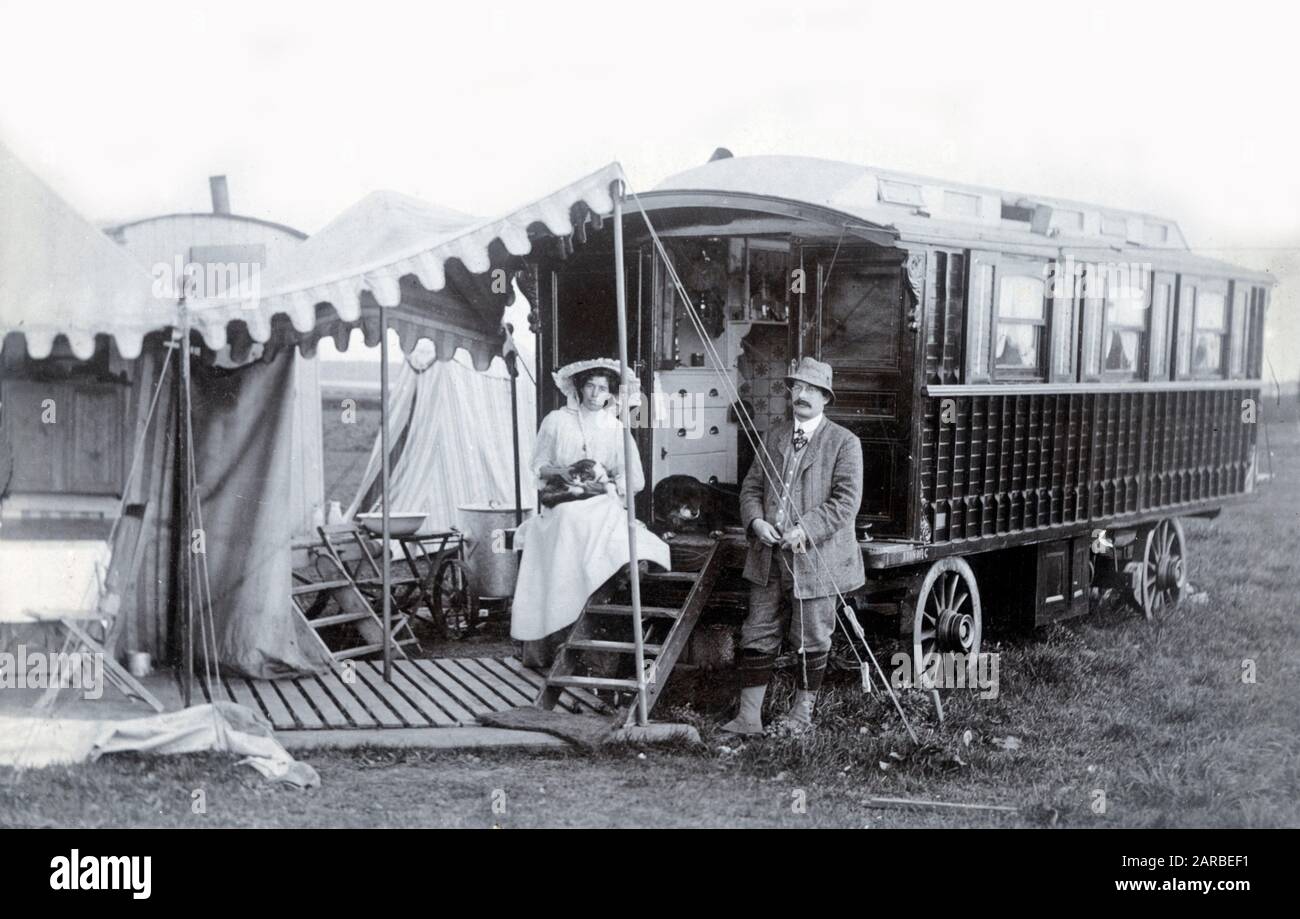 Large and Lavish Gypsy Caravan and its owners (and dog)     Date: 1905 Stock Photo