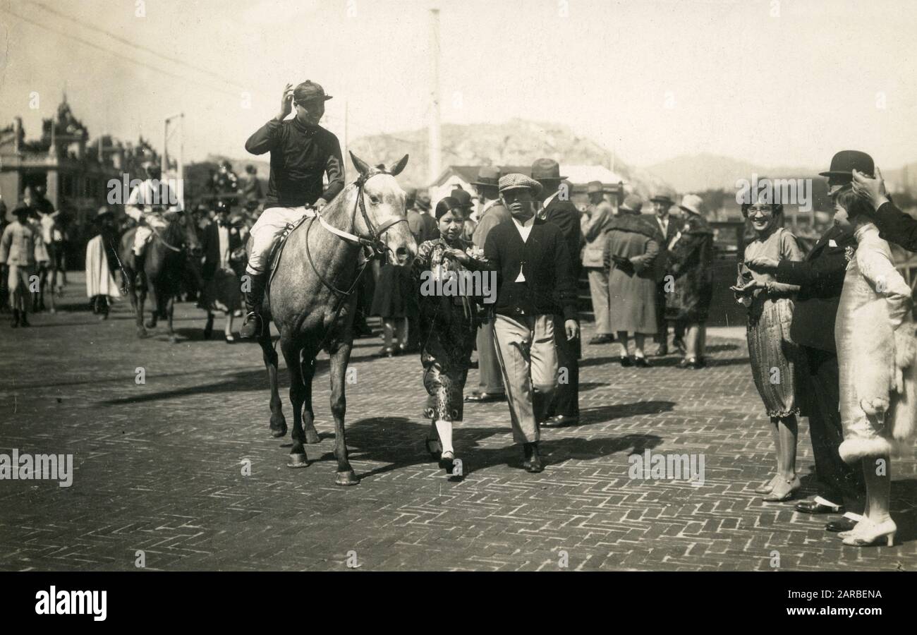 Happy Valley Racecourse, with jockeys, horses and racegoers, Hong Kong, China.       Date: circa 1920 Stock Photo