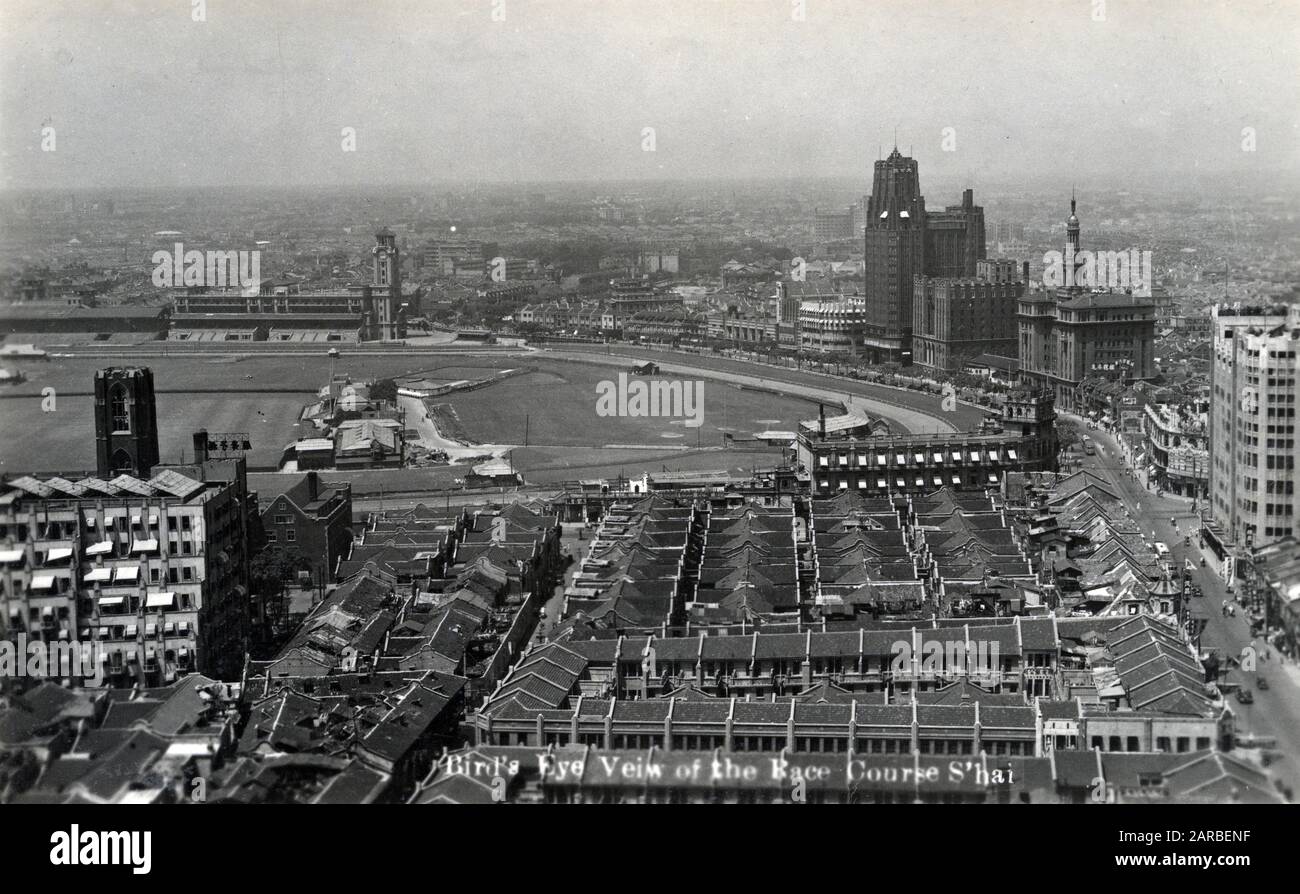 Aerial view of the racecourse with rooftops and baseball ground, skirted by Bubbling Well Road with the high rise Park Hotel, Shanghai, China.      Date: circa 1935 Stock Photo