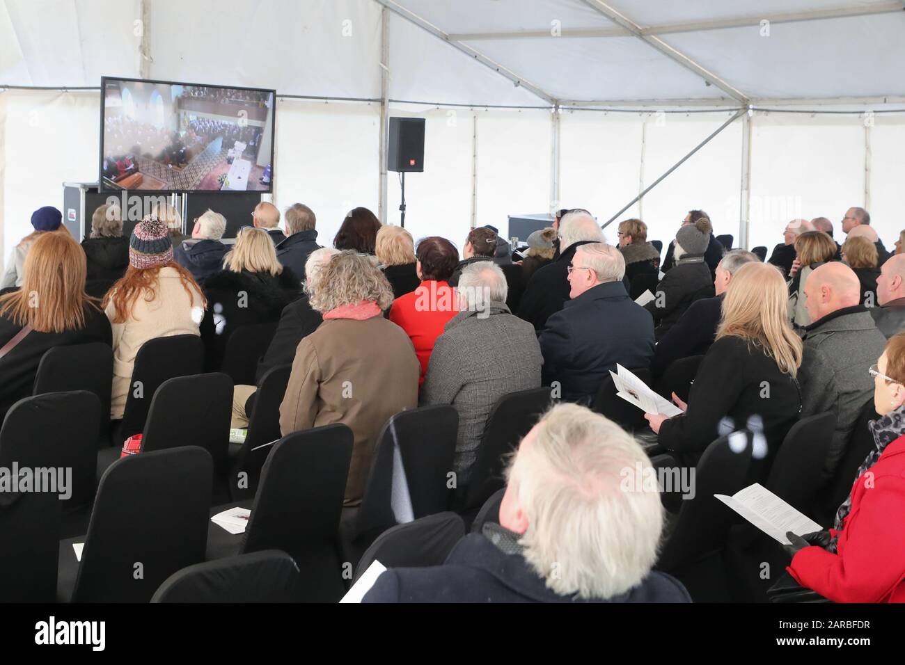 People in an overflow tent watching the funeral of Seamus Mallon, the former deputy first minister of Northern Ireland, at Saint James of Jerusalem Church in Mullaghbrack, Co Armagh. Stock Photo