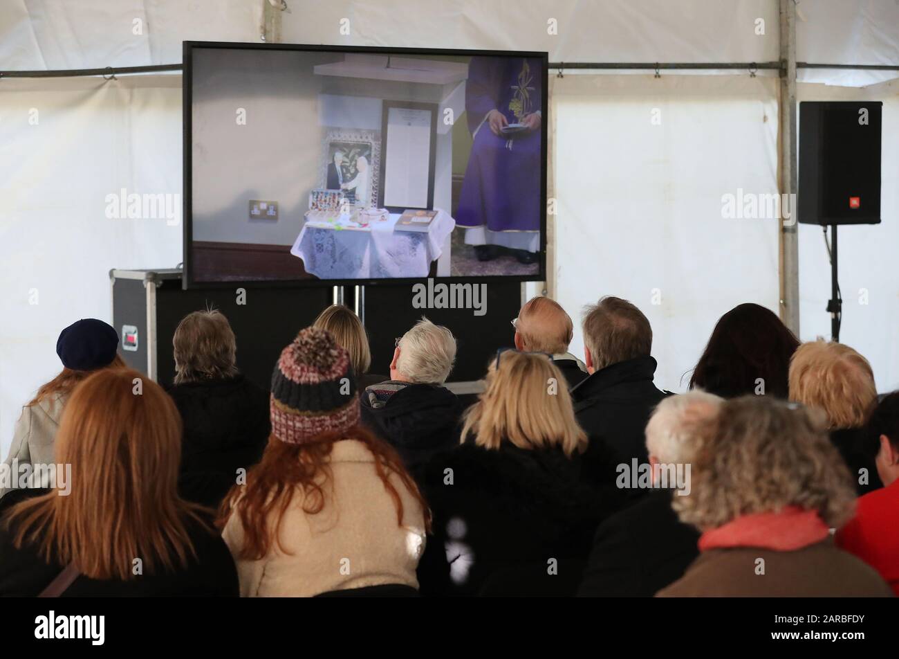 People in an overflow tent watching the funeral of Seamus Mallon, the former deputy first minister of Northern Ireland, at Saint James of Jerusalem Church in Mullaghbrack, Co Armagh. Stock Photo