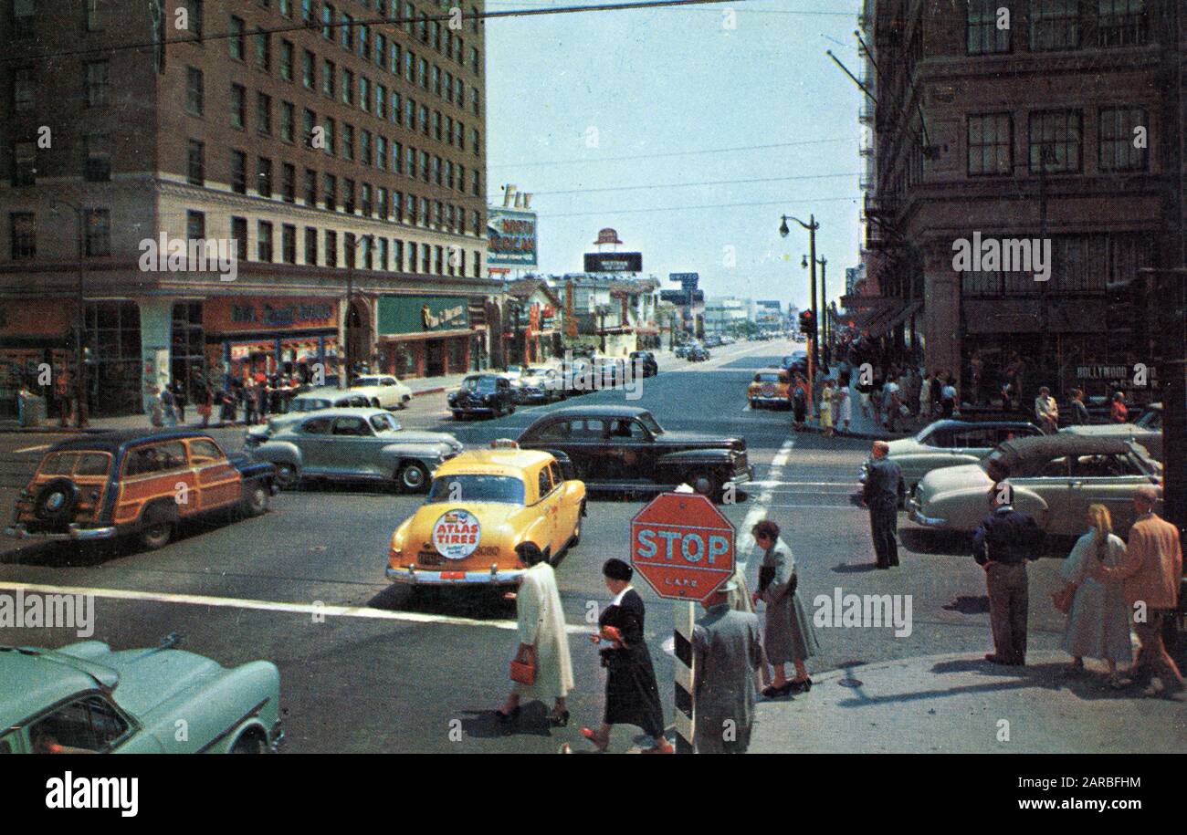 Junction of Hollywood and Vine Street, Los Angeles, California, USA, with cars and pedestrians.      Date: circa 1950s Stock Photo