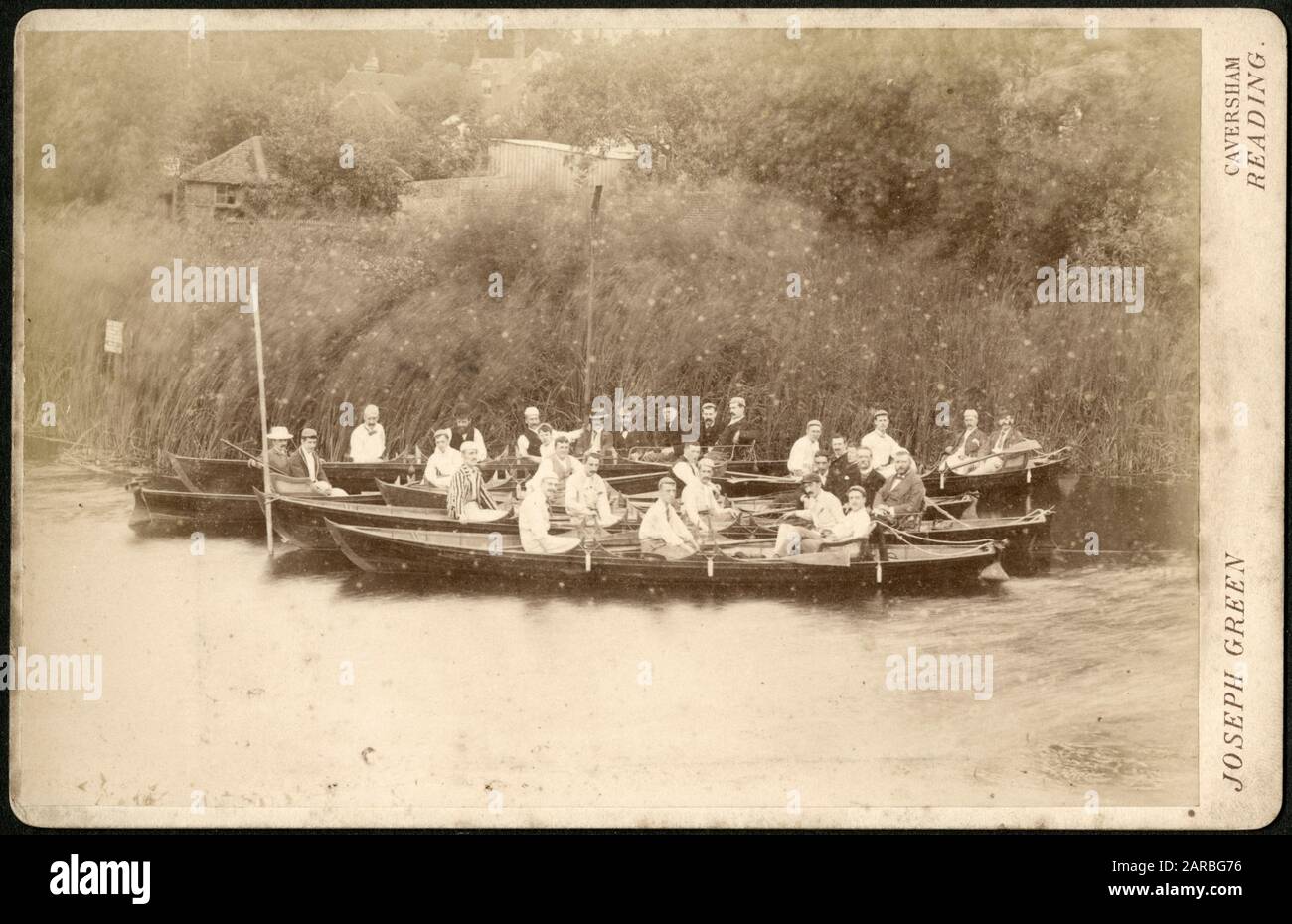 Photograph by Joseph Green, Bridge Street, Caversham, Reading showing a group of jolly chaps having a lot of fun in long rowing boats on the River Thames at Caversham. Stock Photo
