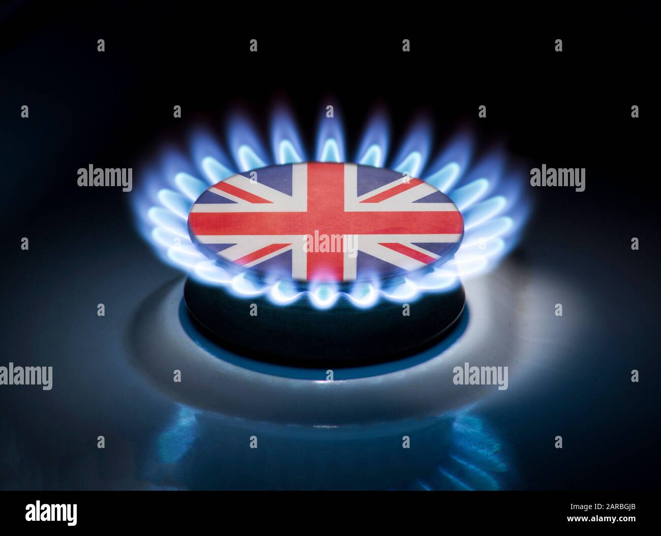 Burning gas burner of a home stove in the middle of which is the flag