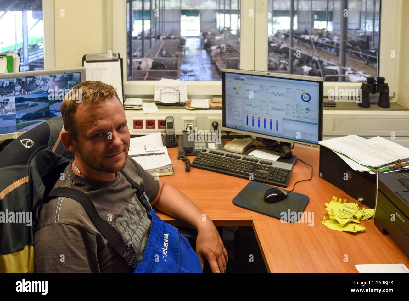 Hamersleben, Germany. 26th Aug, 2019. Sascha Blaik (32), managing director of the agricultural cooperative eG Hamersleben, is sitting in the 'control centre' of his digitalised cow barn. His dairy cows are guided alternately to their feeding areas, a rest area and the milking robots by means of transponders and automatic sluice gates. Credit: Stephan Schulz/dpa-Zentralbild/ZB/dpa/Alamy Live News Stock Photo