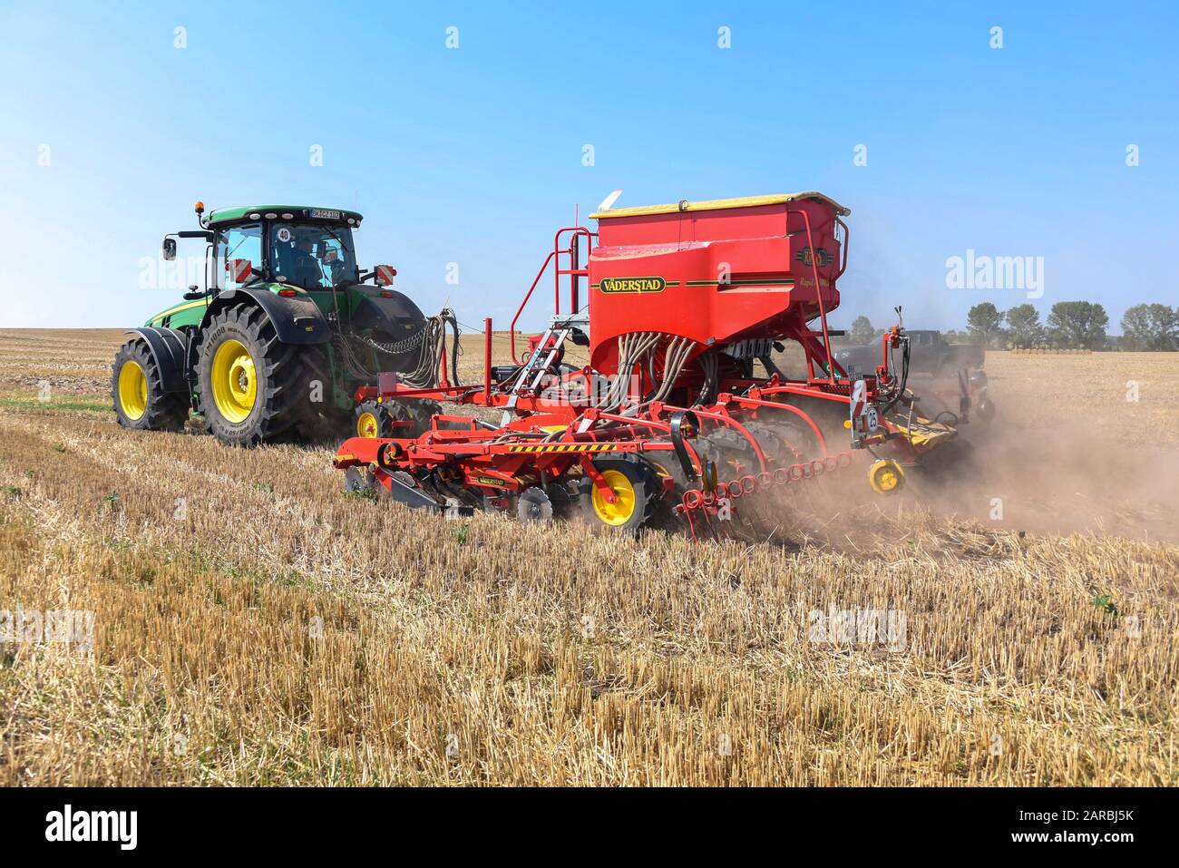 Hamersleben, Germany. 26th Aug, 2019. A high-tech tractor of the agricultural cooperative eG Hamersleben pulls a seed drill behind it for sowing. The machine inserts seeds individually and with centimetre precision into the soil. Credit: Stephan Schulz/dpa-Zentralbild/ZB/dpa/Alamy Live News Stock Photo