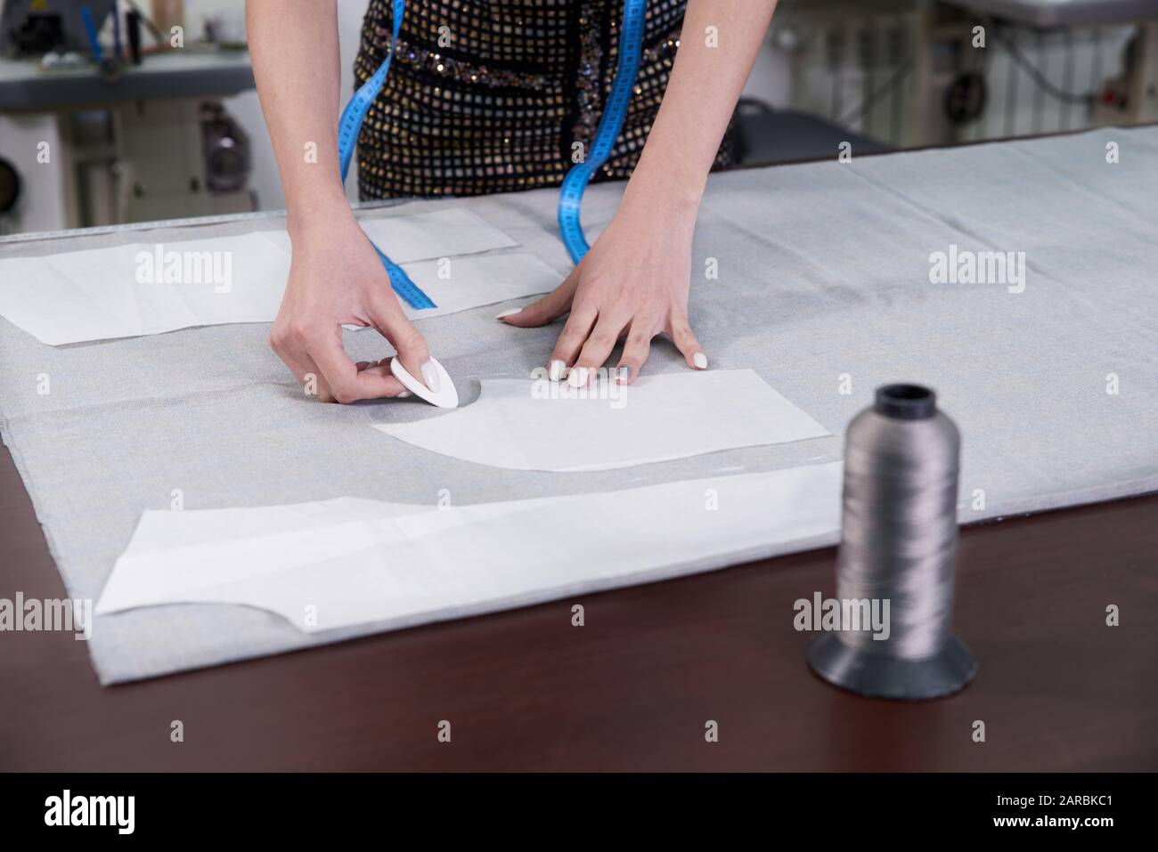 Tailor at work, drawing line on fabric with chalk Stock Photo - Alamy
