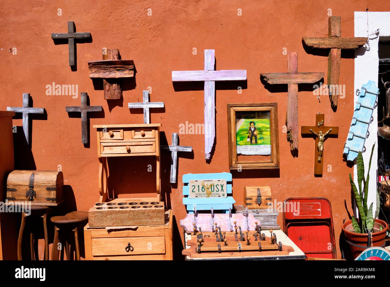 Various artisan items for sale outside an Antique shop.  Fall features a large selection of wooden crosses in  Puebla, Mexico. Stock Photo