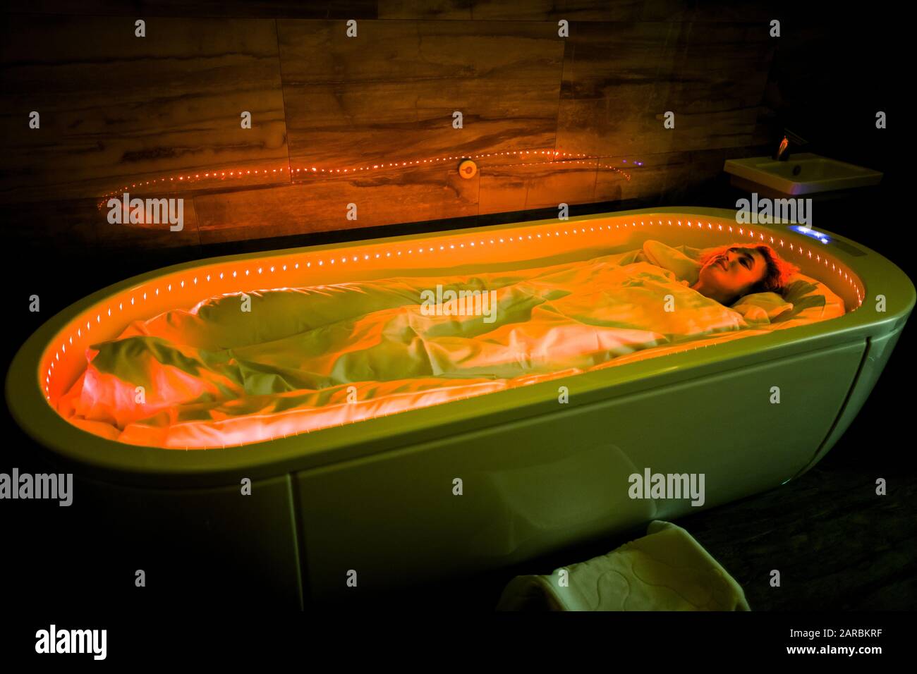 Spa body wraps. Photo of young woman relaxing in spa salon, wrapped