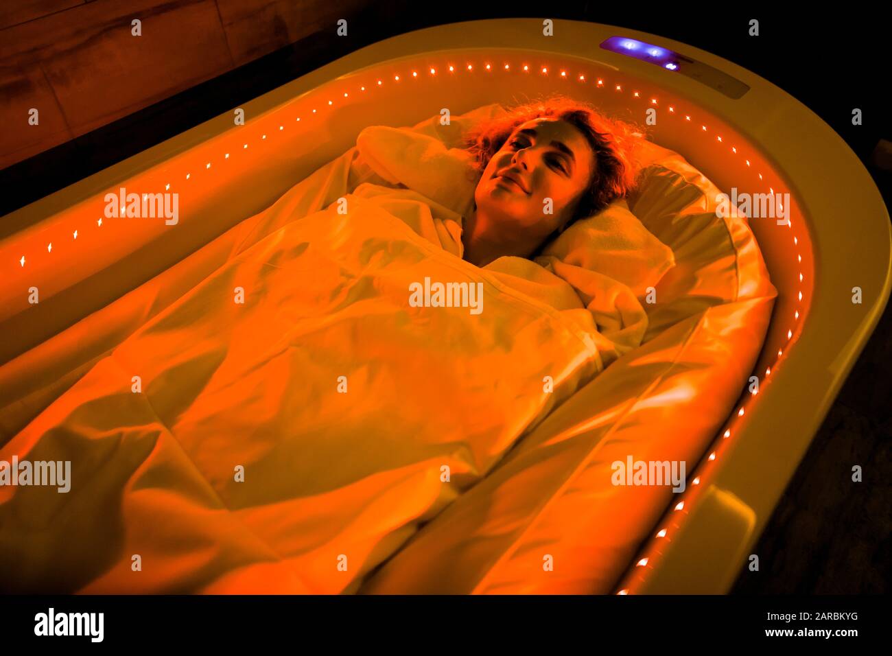 Spa body wraps. Photo of young woman relaxing in spa salon, wrapped