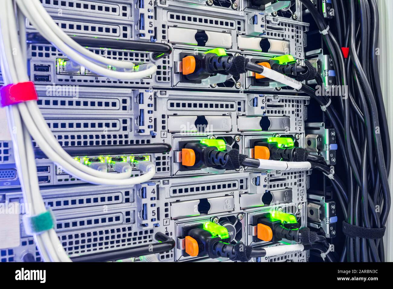 Server network interfaces and electrical wires are close-up. Powerful computer equipment is installed in the datacenter racks Stock Photo