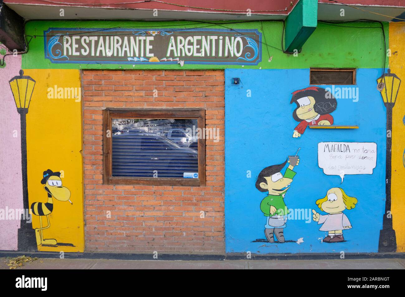 Argentinian restaurant in Mexico City, featuring wall art depicting cartoon character Mafalda, her sister and friend. Stock Photo