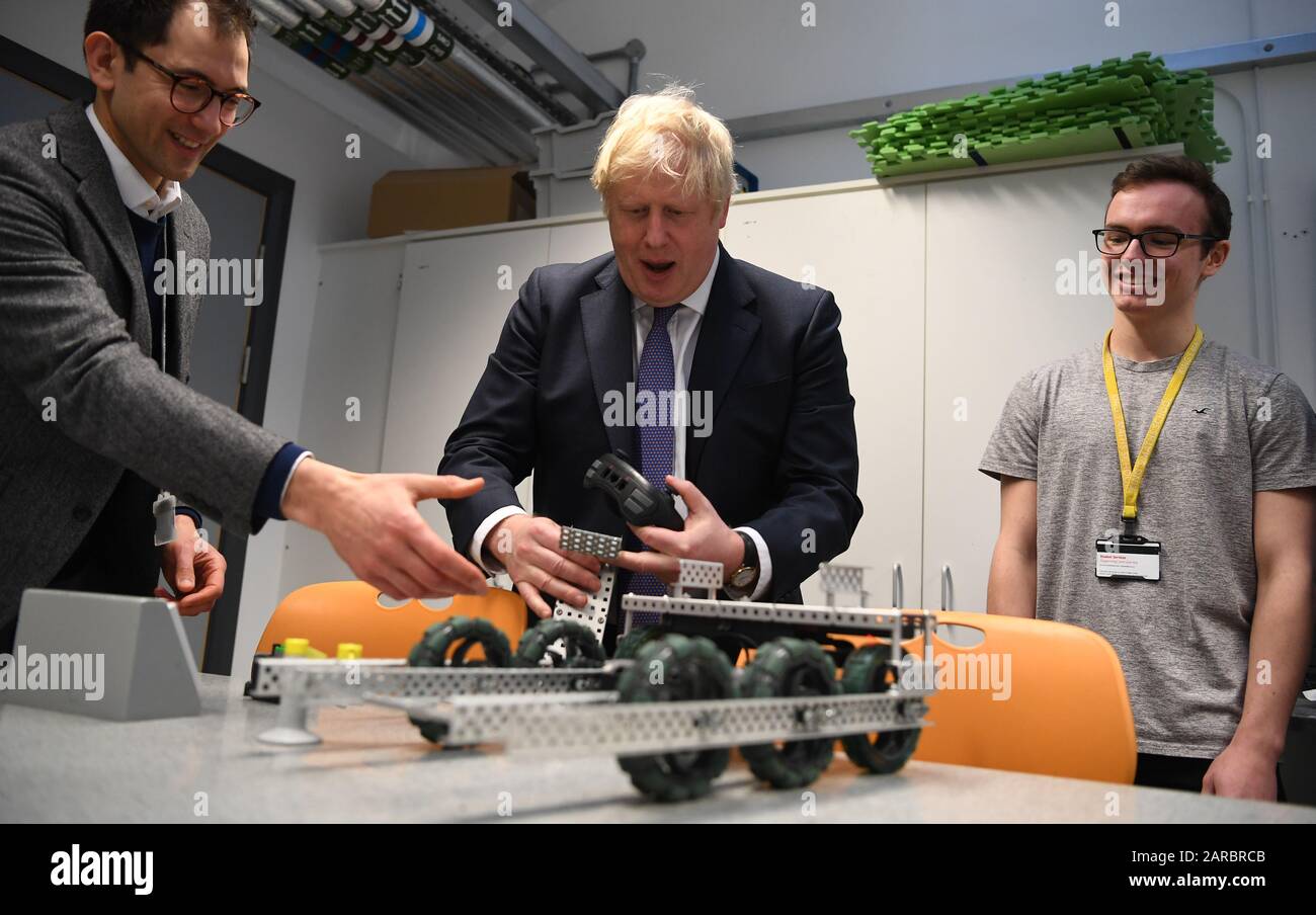 Prime Minister Boris Johnson uses a robot built by students during a visit  to the Department of Mathematics at King's Maths School, run in partnership  with King's College London University in central