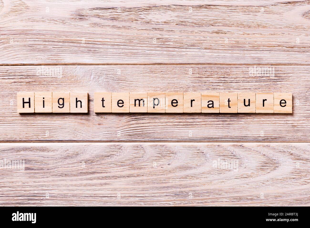 high temperature word written on wood block. high temperature text on wooden table for your desing, coronavirus concept top view. Stock Photo