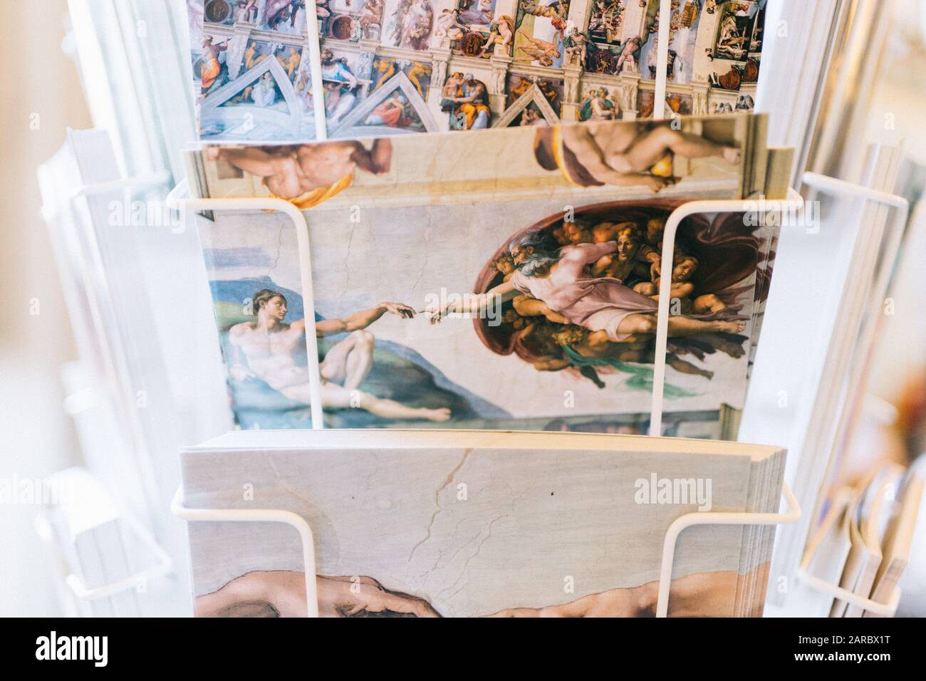 Rome, Italy - Jan 3, 2020: Postcards in a rack in a girft shop inside the Vatican Museum. Stock Photo