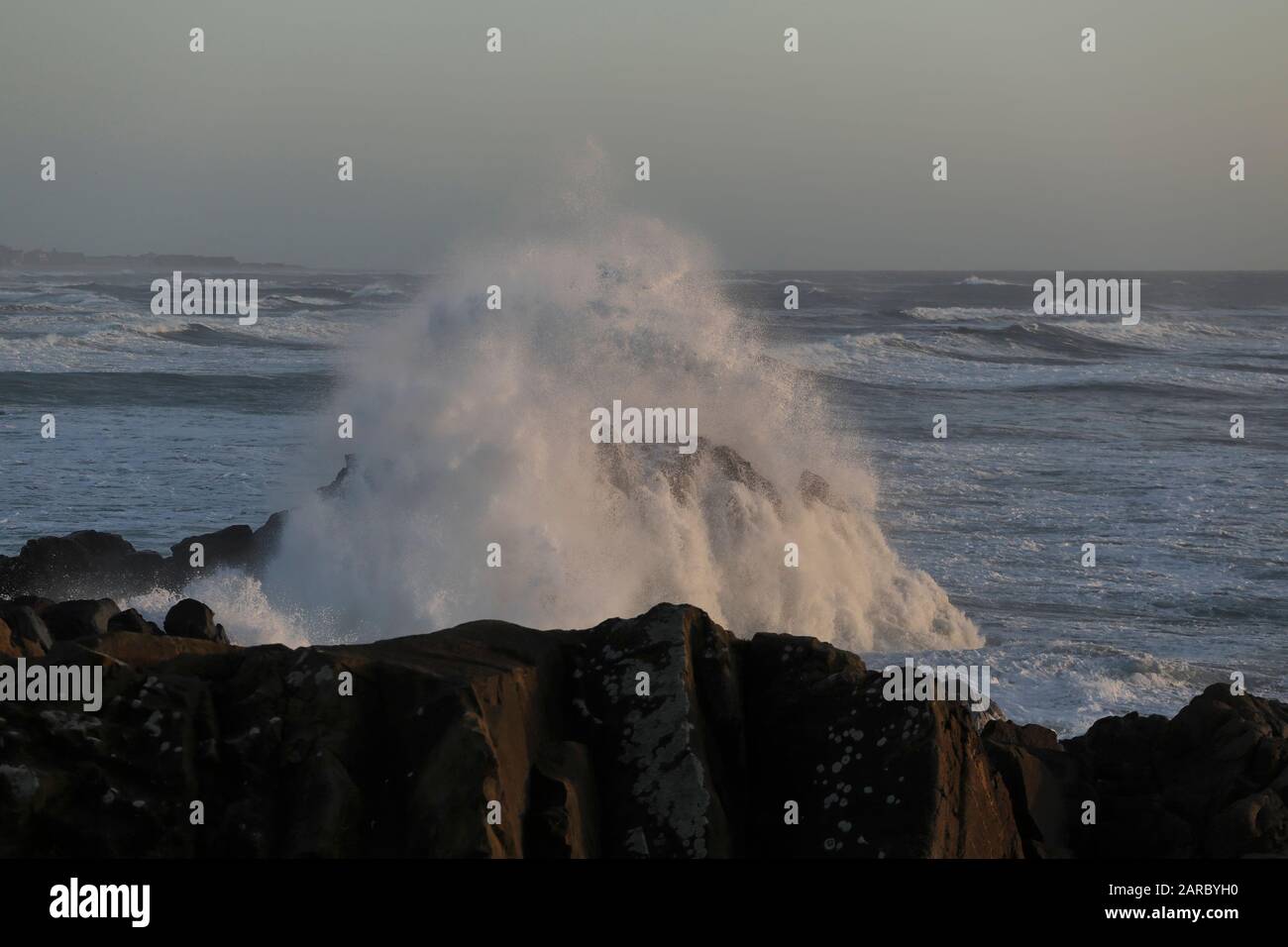 Big wave splash at dusk. Little cape of S. Paio, north of Portugal. Stock Photo