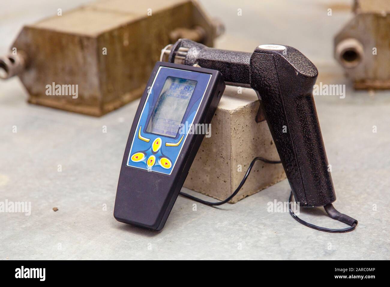 Device for the study of concrete and determine the properties, density and quality of the finished concrete. The device is similar to a gun to which a Stock Photo