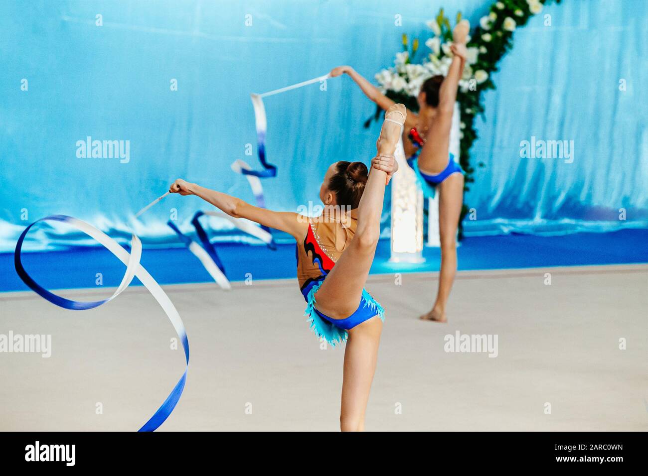group performance girl gymnasts with ribbon in rhythmic gymnastics Stock Photo