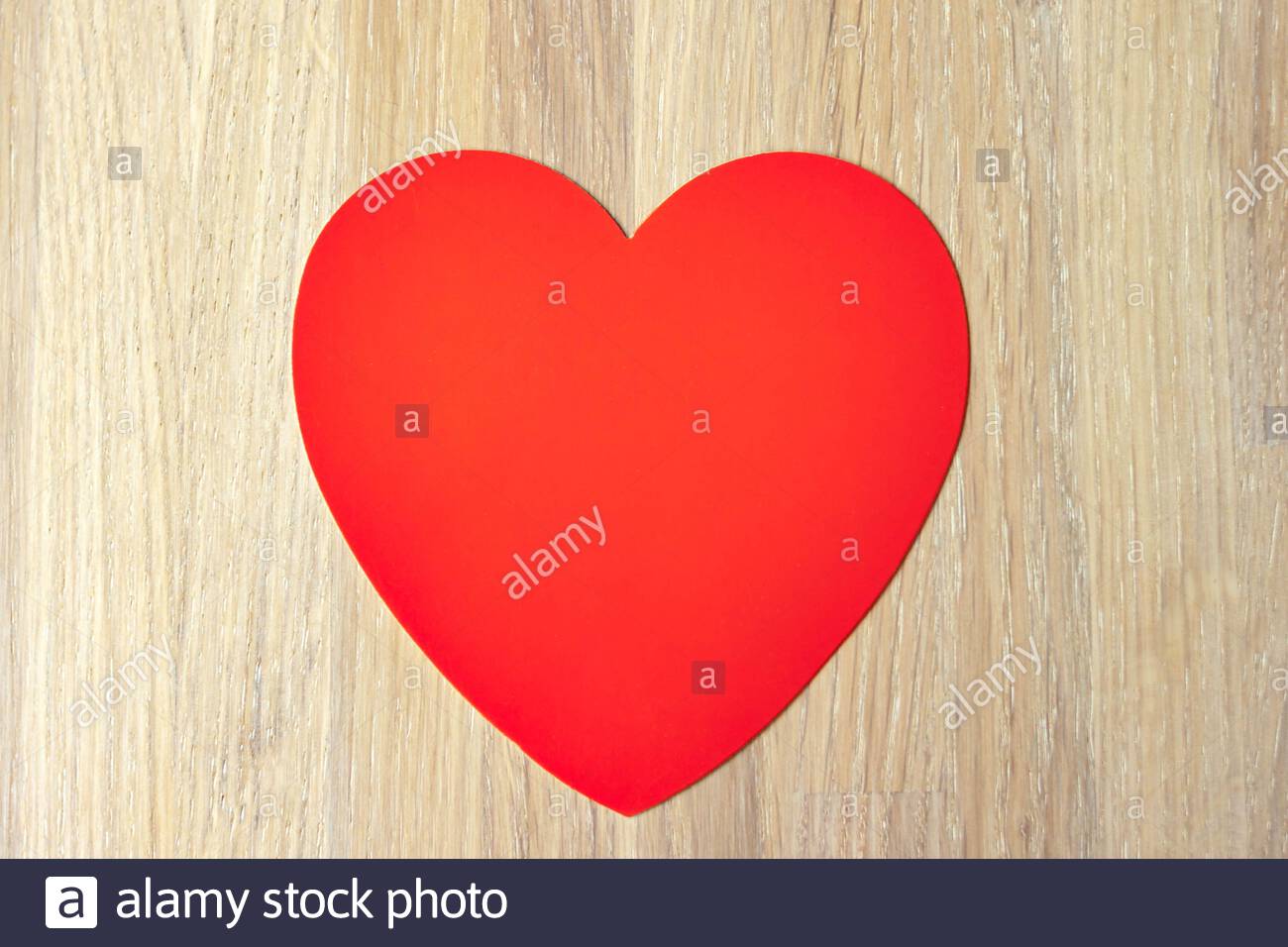 Red Heart On Natural Bleached Oak Wooden Background Close Up View