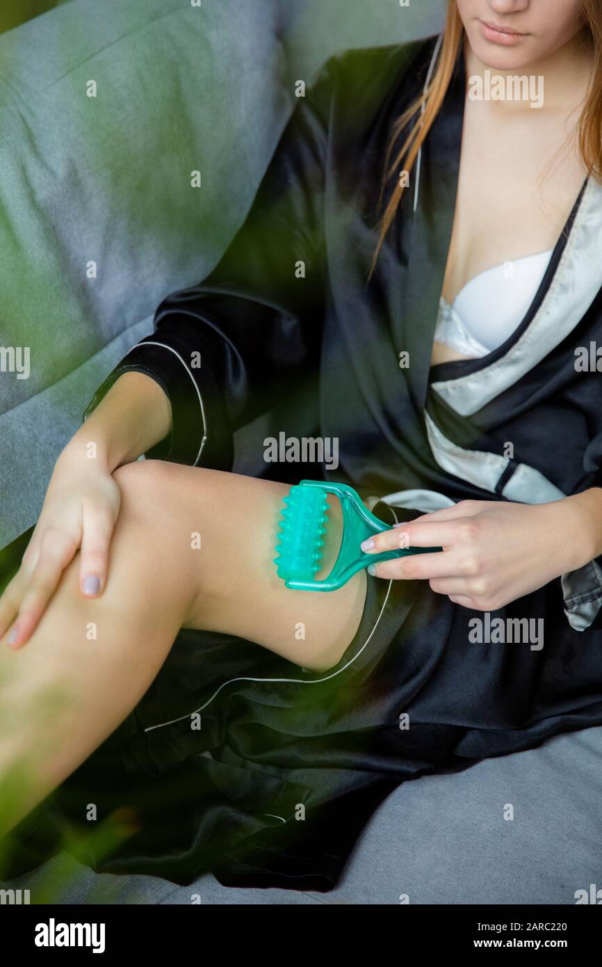 Massage of women's legs with a shock massage device. Shock self-massage to  restore fascia muscles and trigger points Stock Photo - Alamy