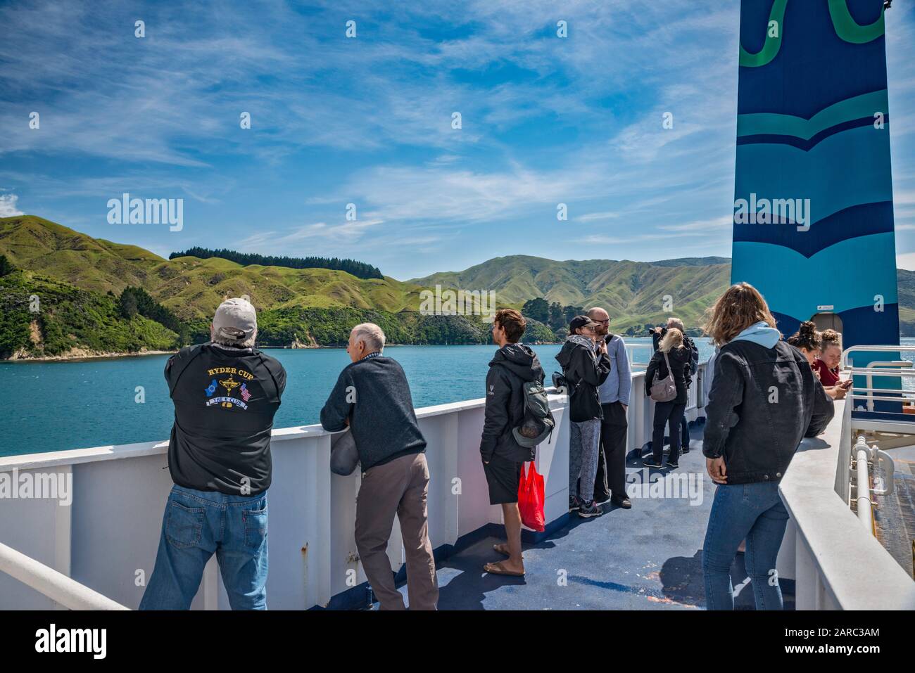Passengers at MS Kaitaki, Interislander ferry, looking at Tory Channel, Marlborough Sounds shoreline, on way to Picton, South Island, New Zealand Stock Photo