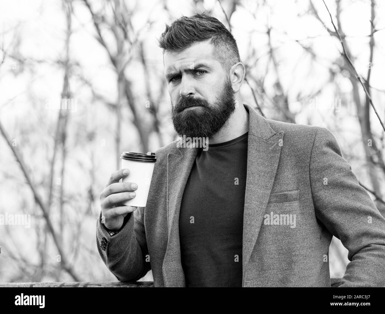 Caffeine gives him energy. Bearded man enjoy coffee in autumn morning. Businessman hold cup of hot energy drink. Being charged with energy. Stock Photo