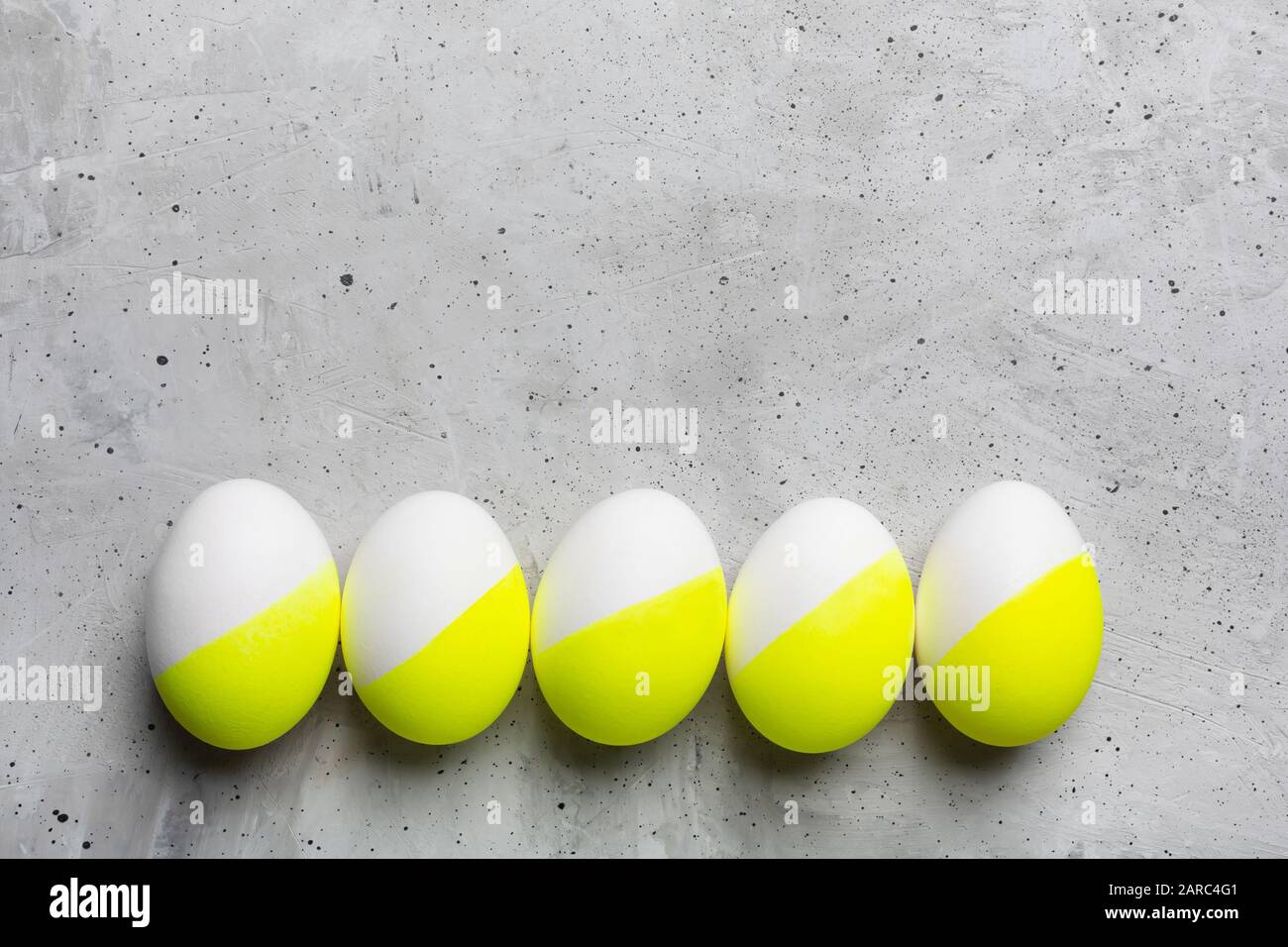 Colored Easter eggs on gray background with copy space Stock Photo